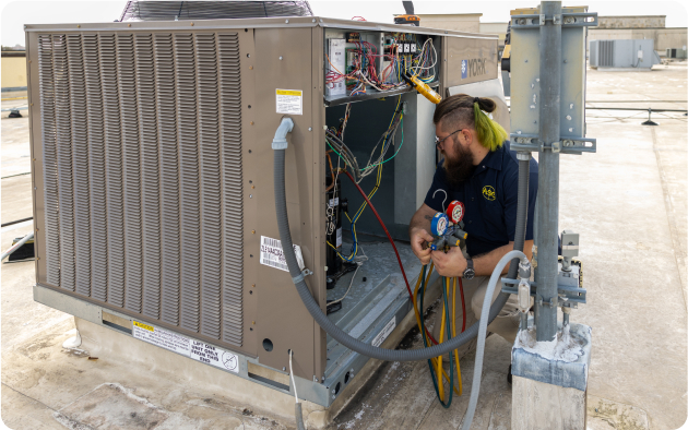 Technician working on commercial HVAC unit