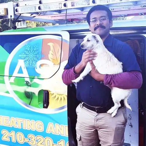 Craig ASC Technician holding Birdie a company mascot
